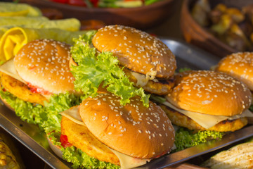 burgers with cheese and salad are on the tray