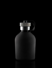 Black vial on a black background with a metal stopper
