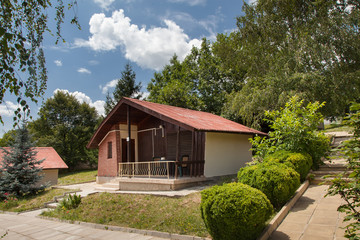 Wooden bungalows and garden in the forest. Holiday apartmens