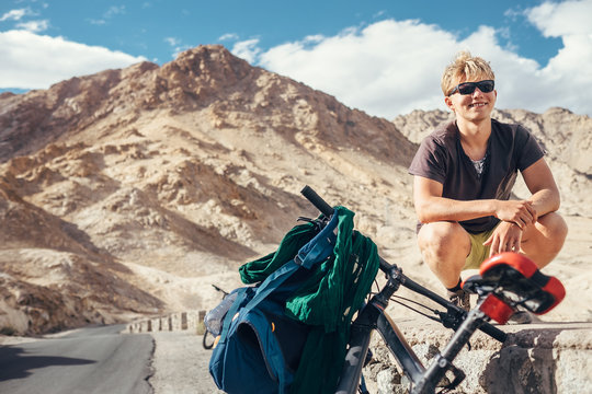 Young tourist man travel with bike in Himalaya montain