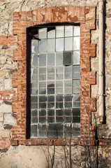 Fototapeta na wymiar Glass iron window of old grunge abandoned vintage industrial building
