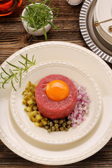 Beef tatare with egg, onion, cucumber and capers