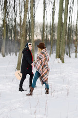 Fototapeta na wymiar young couple dancing in winter forest