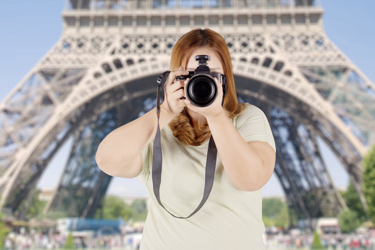 Fat woman with digital camera in Paris