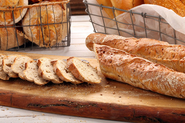 Different types of breads on wooden background