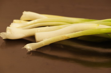 Green fresh onions isolated on a black background