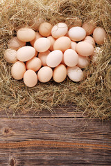 Chicken eggs in hay nest with empty space for text