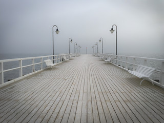 winter view on empty pier covered with frost in perspective