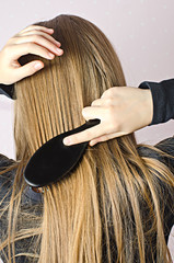 Young girl combing Golden hair