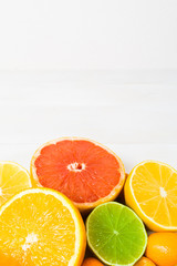 Citrus fruit on the white wooden background