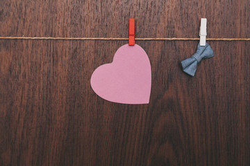 heart and bow tie hanging from the rope