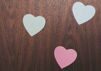 Obraz na płótnie Canvas Three hearts on a wooden board
