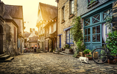 Charming street scene in an old town in Europe at sunset - obrazy, fototapety, plakaty