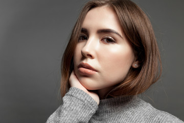 Naklejka premium Portrait of a young girl serious model with clear skin.