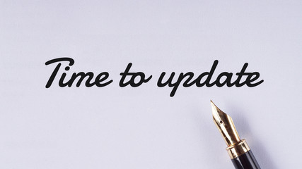 "Time to update" words written on white paper using fountain pen - business and finance concept