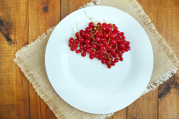 Berries of red currant on the plate
