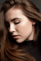 Fototapeta premium Close-up studio portrait of a female model with clear skin, flying hair.