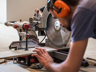 a man working with a miter saw