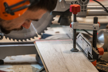 a man working with electric saw