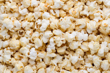 Popcorn background. Caramel sweet corn. Cinema snack.