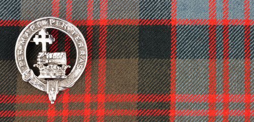 Scottish MacDonald Clan Family Crest On Tartan Fabric Background