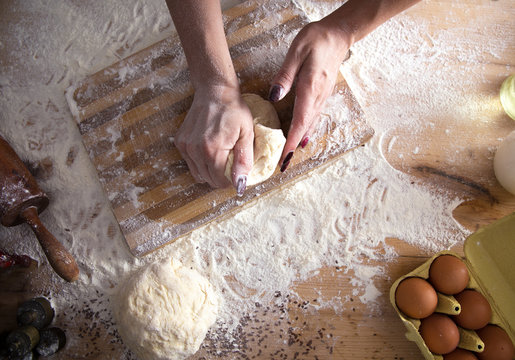 Top View Of Female Baker Hands Kneading Dough And Making Bread