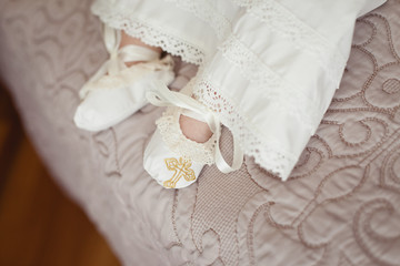 Little baby's legs in Christening textile booties