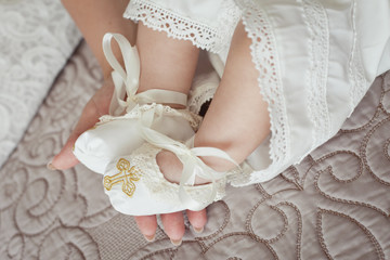 Little baby's legs in Christening textile booties