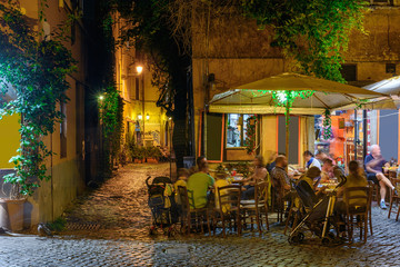Fototapeta na wymiar Night view of old street in Trastevere in Rome, Italy