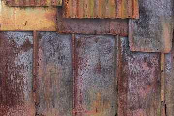 Backdrop of the barn covered with old rusty tin sheets and slate, background