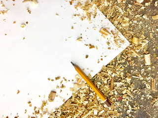 Blank paper on wooden table with sawdust top view