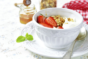 Healthy organic breakfast with granola,yogurt and strawberry.