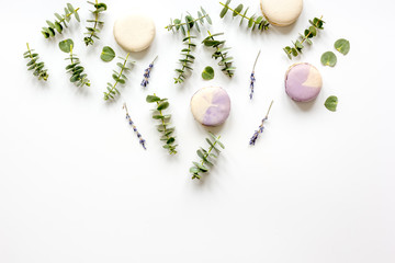 Trendy design with macaroons and flowers on white background top view mockup