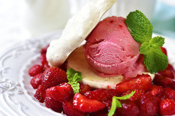 Strawberry dessert with coconut meringue,ice cream and strawberry mint sauce.