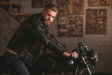 Fototapeta na wymiar Guy in motorbike repair shop