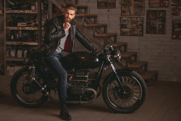 Guy in motorbike repair shop