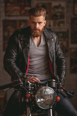 Fototapeta na wymiar Guy in motorbike repair shop