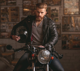 Guy in motorbike repair shop