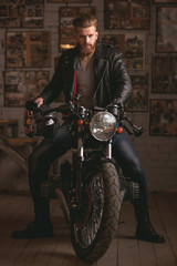 Obraz na płótnie Canvas Guy in motorbike repair shop