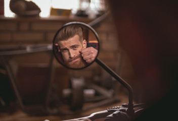 Guy in motorbike repair shop