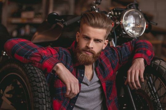 Guy in motorbike repair shop