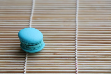 Obraz premium Mini Macarons on bamboo mat colorful deserts