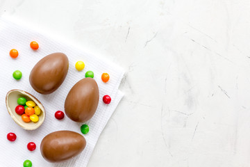 Easter chocolate eggs top view on stone background mock up