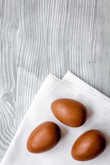 Easter chocolate eggs top view on wooden background mock up