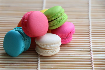 Mini Macarons on bamboo mat  colorful deserts