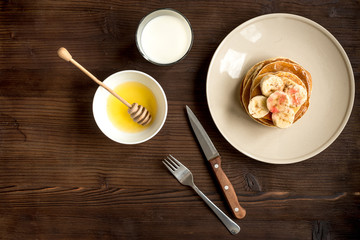 cooked pancake on plate top view at wooden background