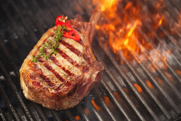 food meat - beef steak on bbq barbecue grill with flame