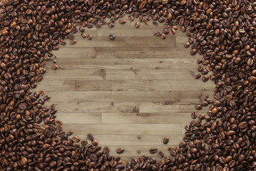 Frame of coffee beans, wood planks background
