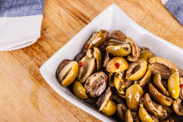 green olives bowl on cutting board