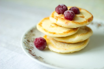 pancakes with cottage cheese on light plate.